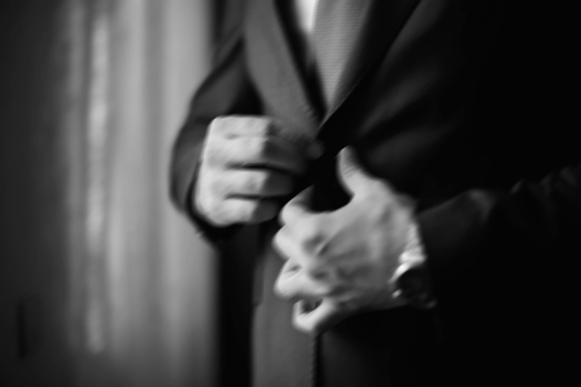 Fastening a suit jacket, motion-blurred