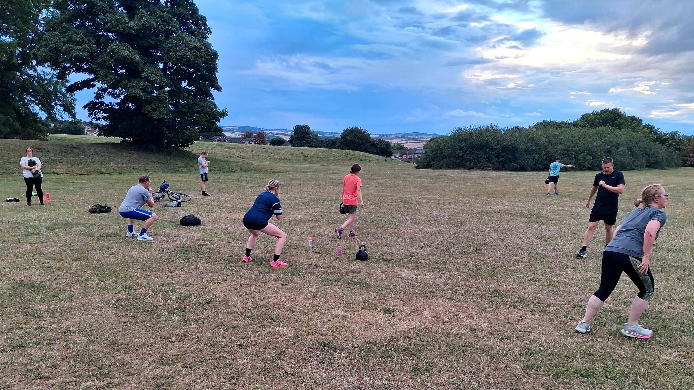 A CommFit class training on the field in Whickham on a summer evening